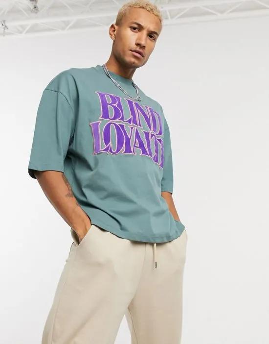oversized t-shirt with corduroy applique text in green