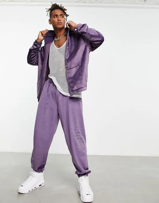 oversized velour sweatpants with diamante text detail in purple