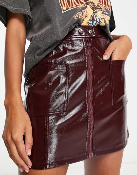 patent zip front pocket mini skirt in burgundy