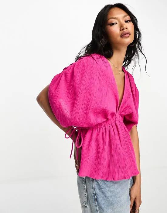 plunge front crinkle top with tie side in bright pink