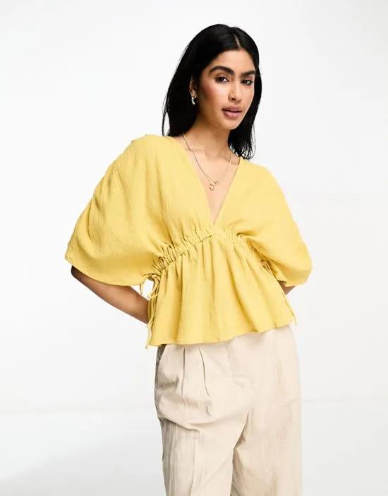 plunge front crinkle top with tie side in ochre