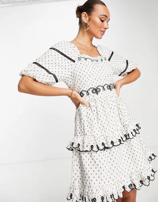 puff sleeve embroidered mini dress in white polka dot