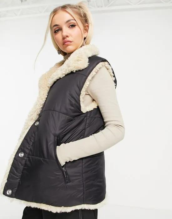 puffer vest jacket with reversible sherpa lining in black