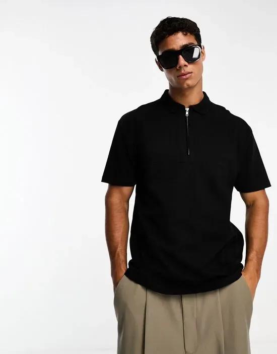 relaxed fit polo with chest seam detail and zip neck in black