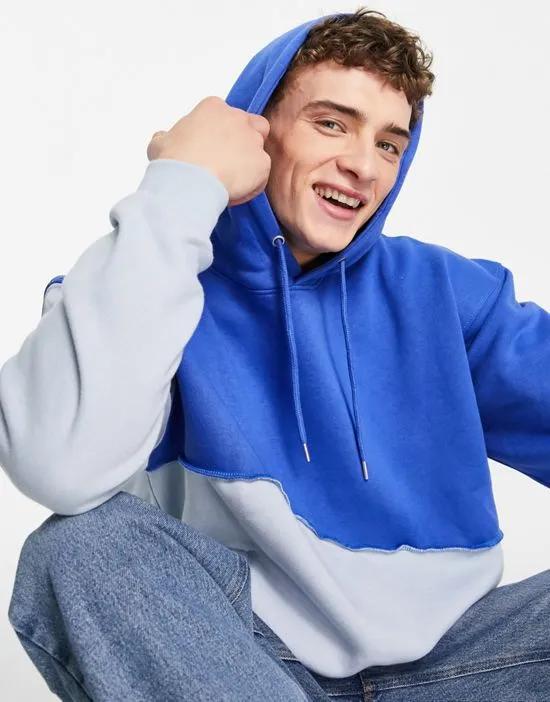 relaxed hoodie in two tone blue with exposed seam detail