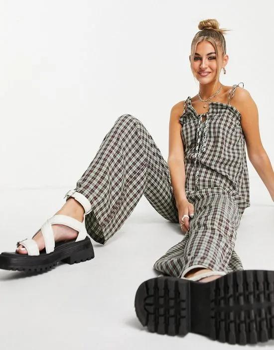 relaxed jumpsuit in grunge check print with tie front and straps