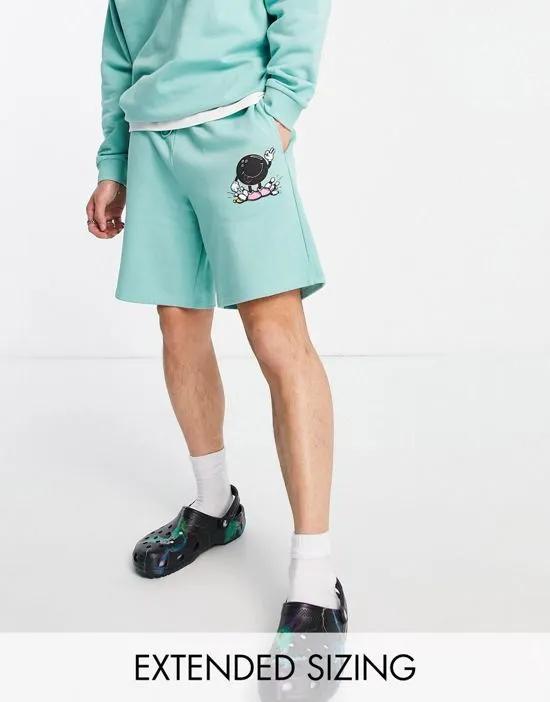 relaxed shorts with bowling graphic print in teal green