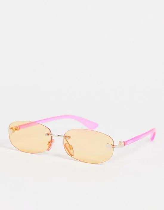 rimless narrow sunglasses in pink with orange tinted lens