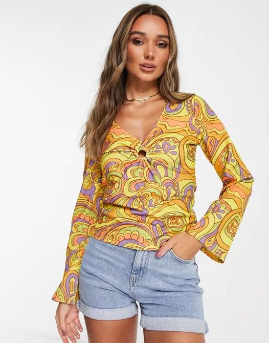 ring detail top with flared sleeves in 60s retro print