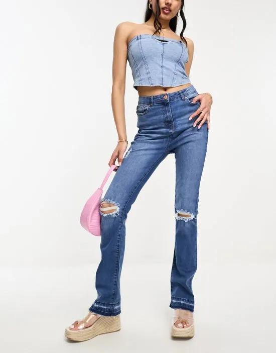 ripped knee distressed flared jeans in mid blue