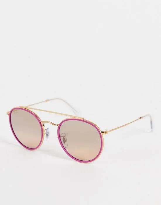 round sunglasses in pink/gold
