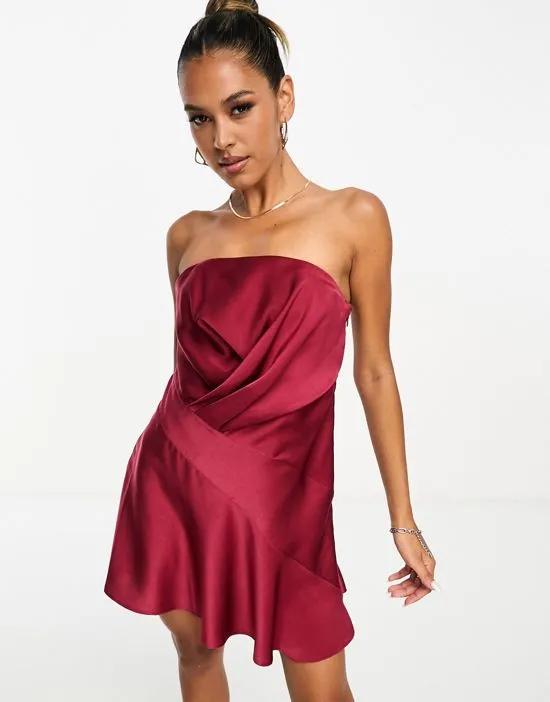 satin bandeau asymmetric hem mini dress with ruched bodice detail in burgundy
