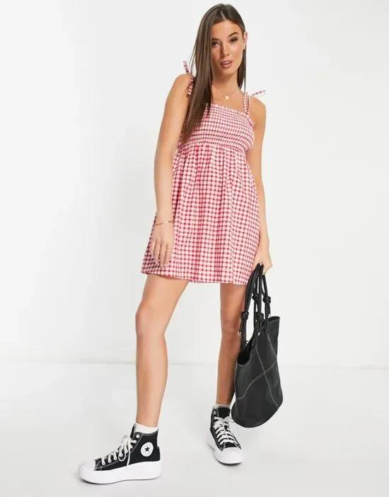 shirred strappy mini sundress in red gingham
