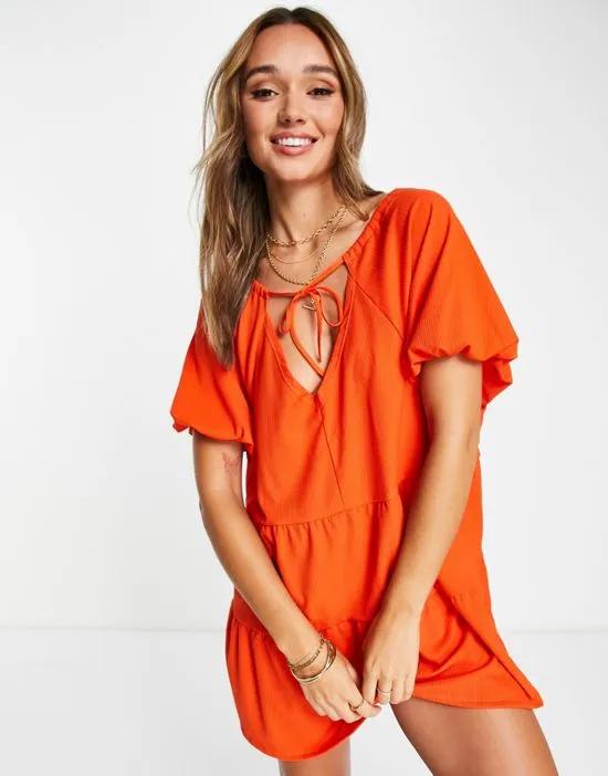 short sleeve tiered smock mini dress in bright orange