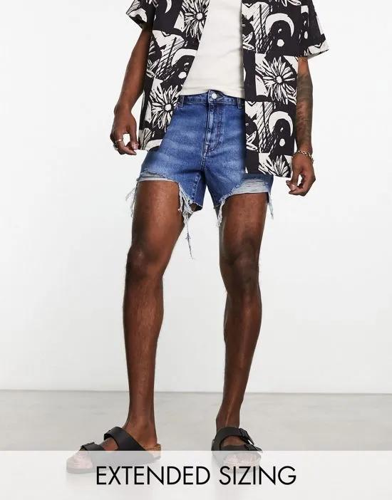 shorter length denim shorts in midwash with rip detail and raw hem