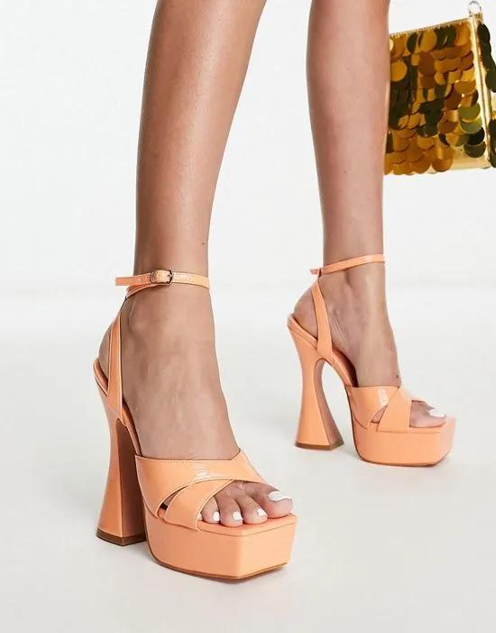 Simmi London Oceani platforms with flared heel in apricot patent