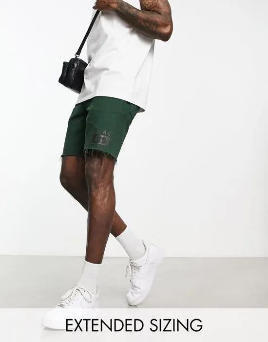 skater denim shorts in green with varsity print