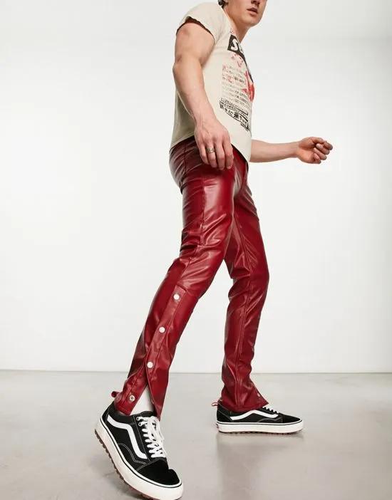 skinny jean with split hem and snaps detail in red leather look