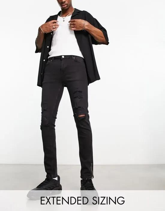 skinny jeans in black with knee rips and zip detail