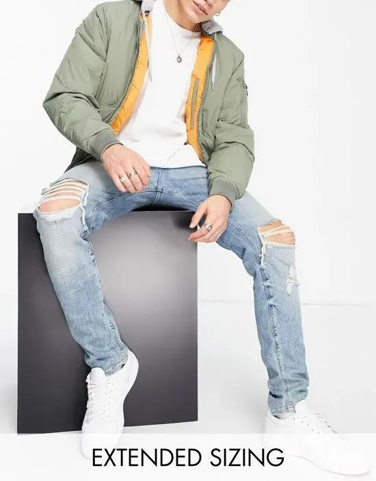 skinny jeans in light wash with heavy rips