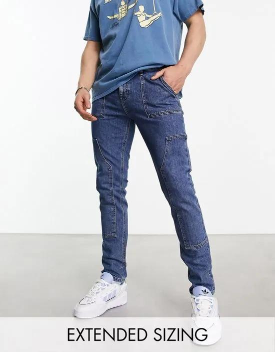 skinny jeans with carpenter detail in mid wash blue