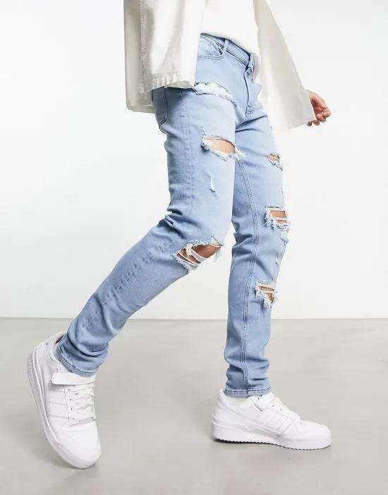 skinny jeans with rips in light wash blue