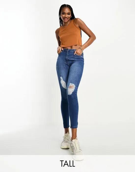 skinny jeans with rips in mid wash blue