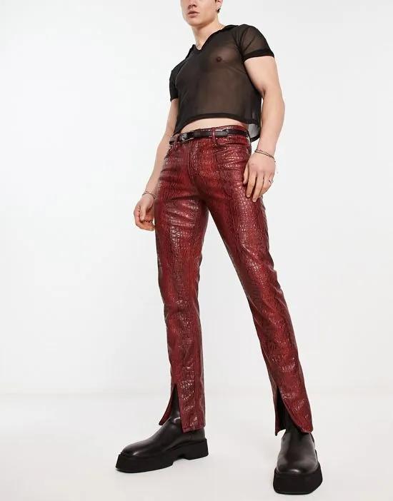 skinny leather-look pants in red snake print with front split hem