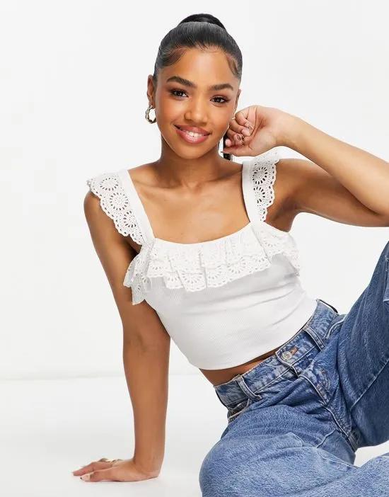 sleeveless broderie ruffle crop top in white