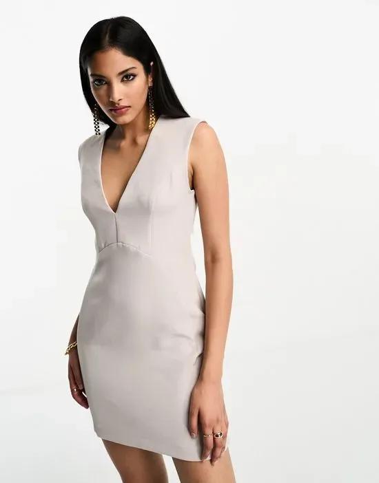 sleeveless plunge neck mini dress with curved waist seam in stone