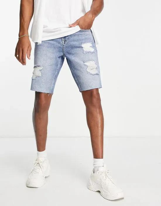 slim denim shorts in mid blue wash with heavy rips