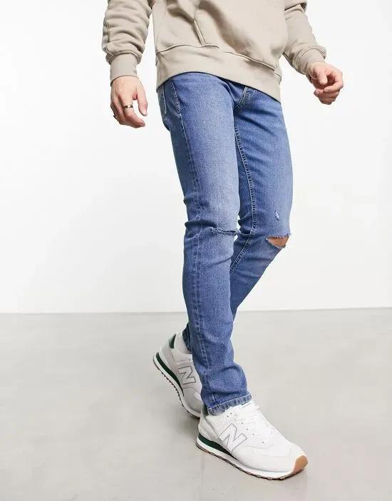 slim fit ripped jeans in mid blue