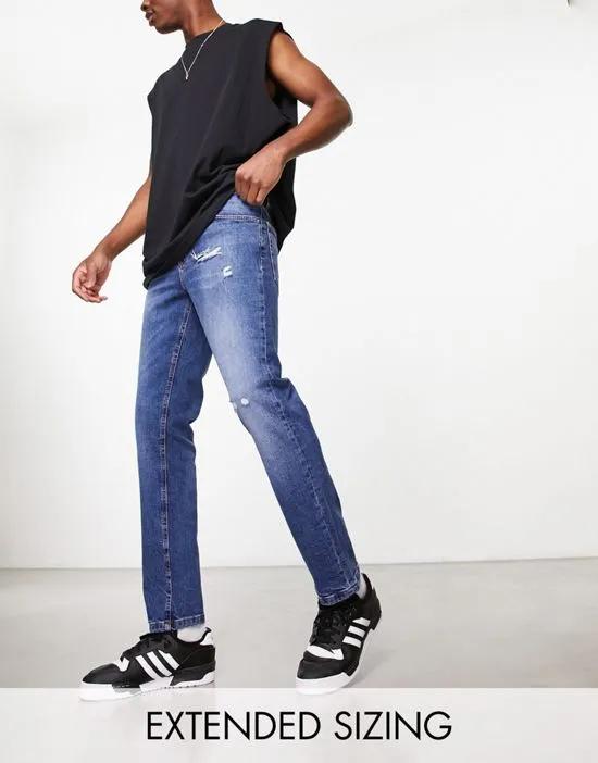 slim jeans with abrasions in mid wash blue