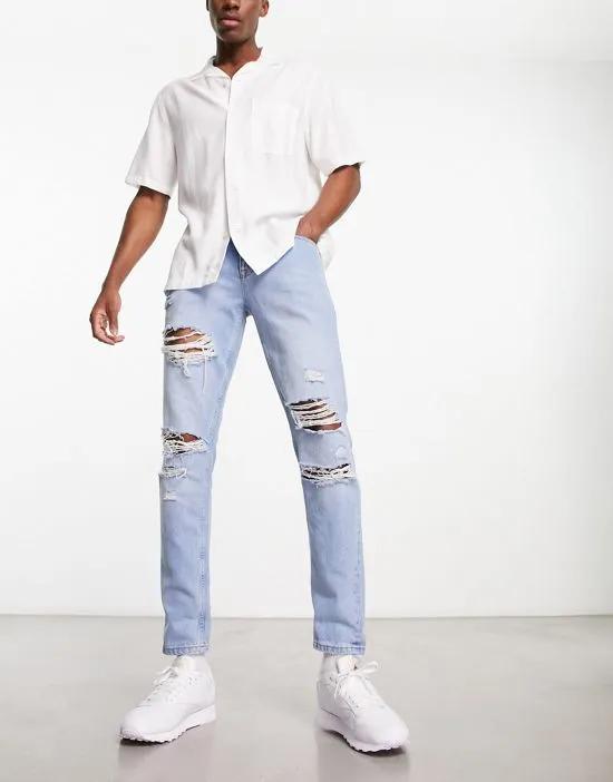 slim jeans with rips in light wash blue