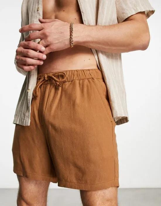 slim linen shorts in shorter length in tan