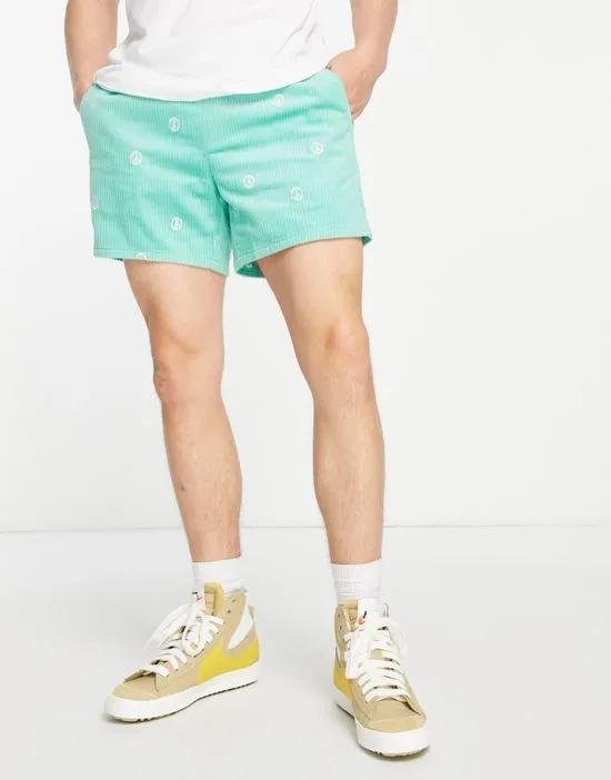 slim shorts with peace embroidery in mint cord