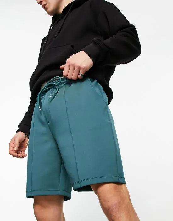 smart slim shorts in green scuba