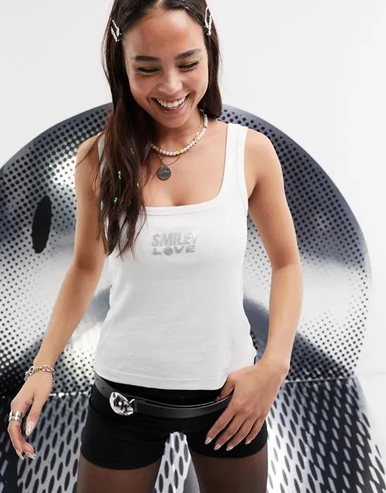 Smiley Collab ribbed square neck tank top with foil slogan license graphic in white