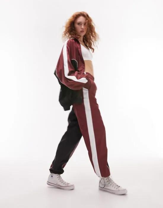 sporty shell cuffed tracksuit bottoms in burgundy - part of a set