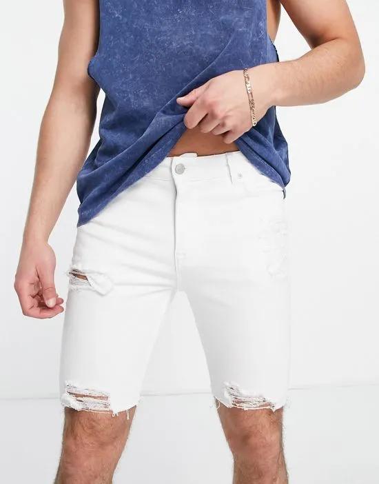 spray on denim shorts with power stretch in white with heavy rips and raw hem