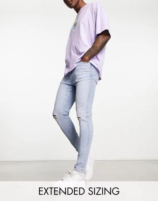 spray on jeans with power stretch and knee rips in light wash blue