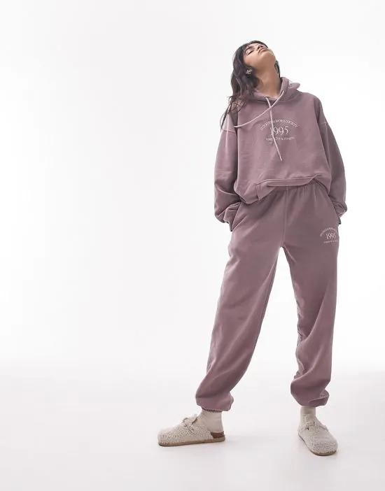 stockholm embroidered vintage wash oversized cuffed sweatpants in plum - part of a set