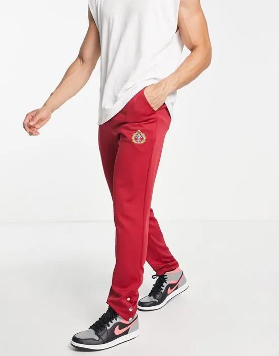straight leg sweatpants in burgundy with golf club embroidery and snap hem