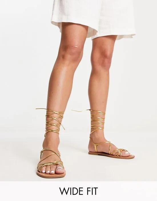 strappy tie leg flat sandals in gold