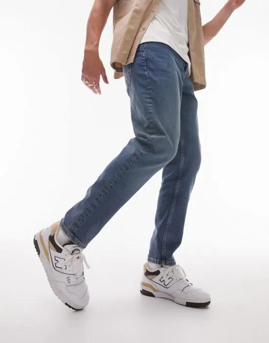 stretch tapered jeans in mid wash