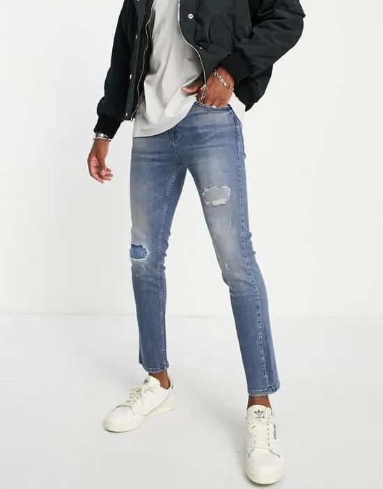 super skinny jeans with rips in light blue