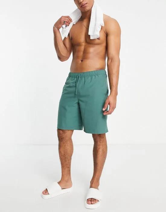 swim shorts in long length in dark green