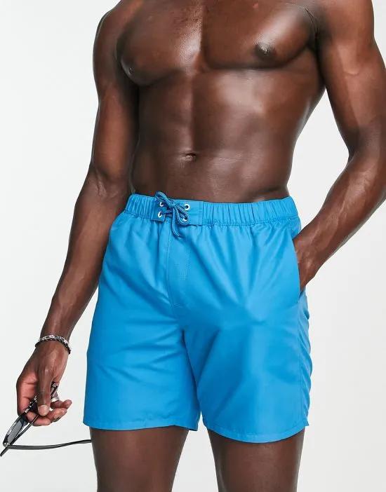 swim shorts in mid length with eyelets in bright blue