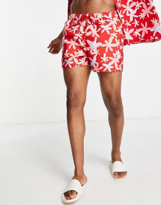 swim shorts in short length with floral print in red - part of a set