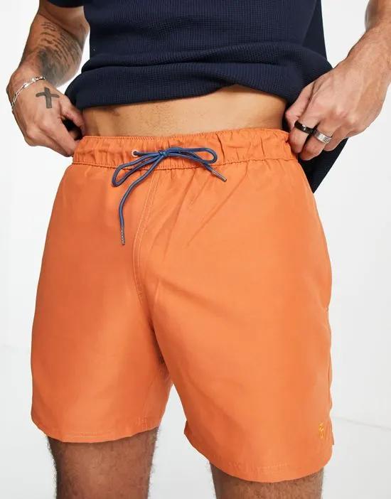swim trunks in orange